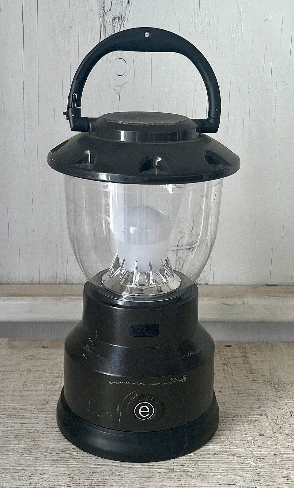 A black LED camping lantern with a clear globe and a top carry handle, for storm prep in Cedar Rapids, IA