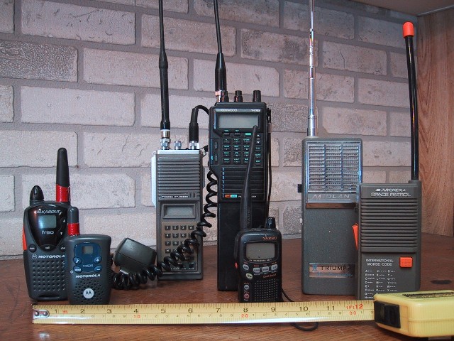 Several handheld walkie-talkies of different makes standing side by side, for storm prep in Cedar Rapids, IA
